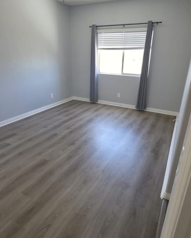 Bedroom with gray SPC flooring and gray walls